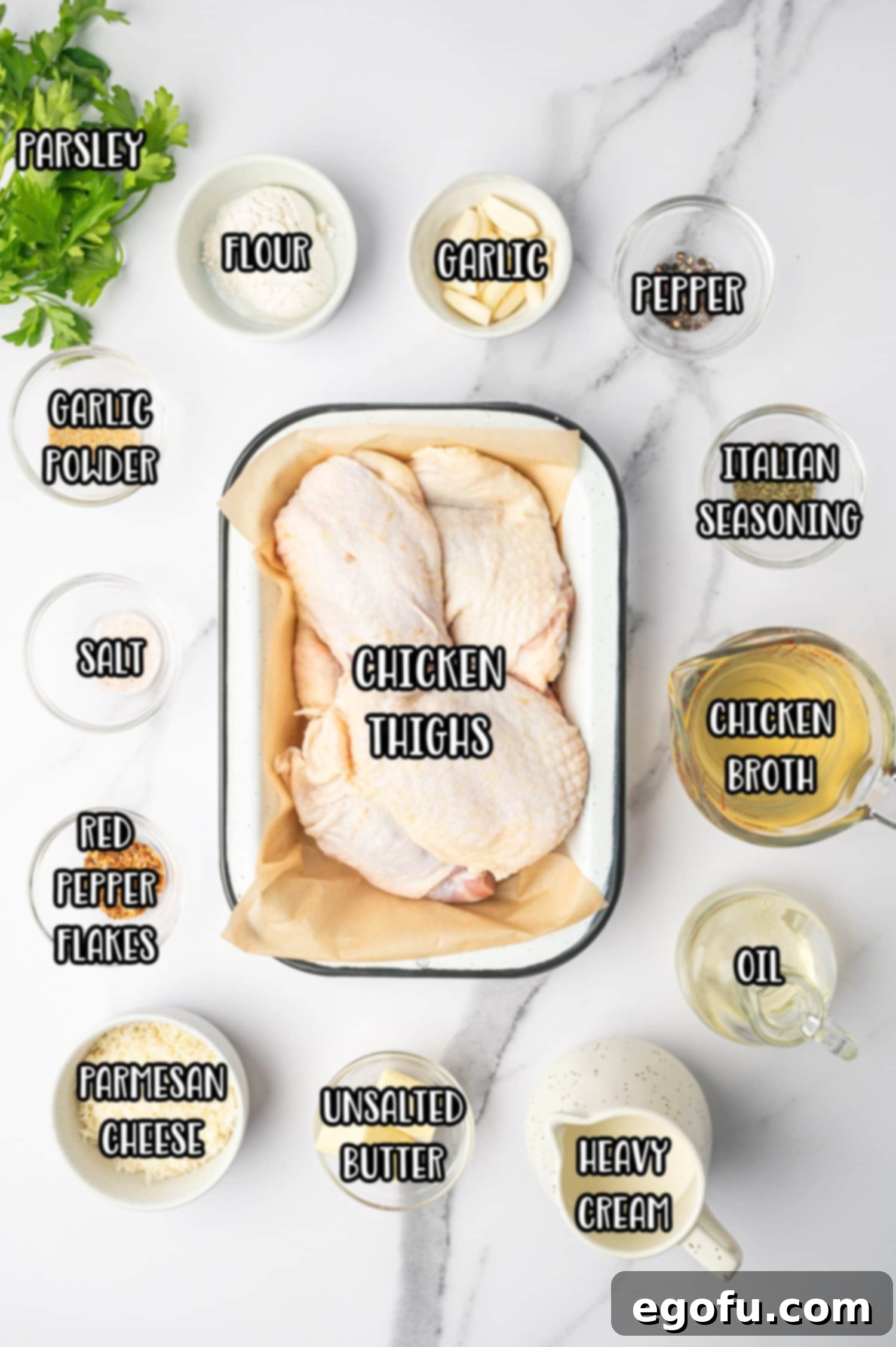 Creamy Garlic Chicken Delight 4 A vibrant flat lay image showcasing all the fresh ingredients needed for Creamy Garlic Chicken: raw chicken thighs, heavy cream, garlic cloves, chicken broth, Parmesan cheese, fresh herbs, and spices.