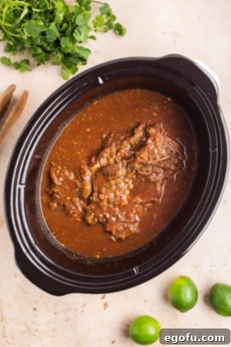 Cooked roast in broth in a Slow Cooker.