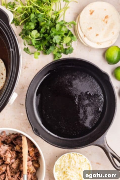 Oil being heated in a cast iron skillet.