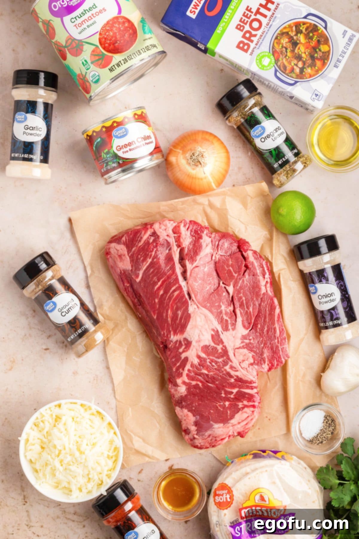 Chuck roast, oil, salt, pepper, low sodium beef broth, crushed tomatoes, yellow onion, green chiles, garlic cloves, honey, cumin, oregano, paprika, onion powder, garlic powder, tortillas, mozzarella cheese, lime wedges, and cilantro.