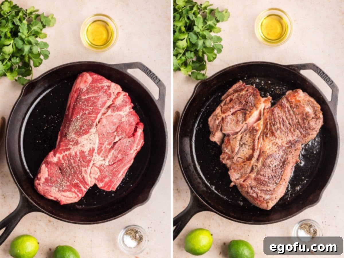 A Chuck roast searing in a cast iron skillet.