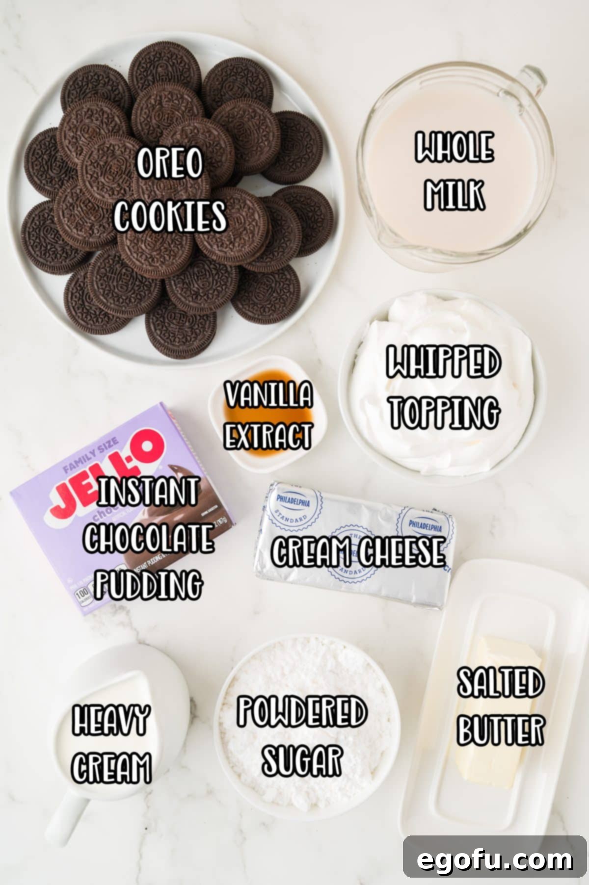 Oreo cookies, whipped topping, whole milk, instant chocolate pudding, cream cheese, salted butter, powdered sugar, and vanilla extract.