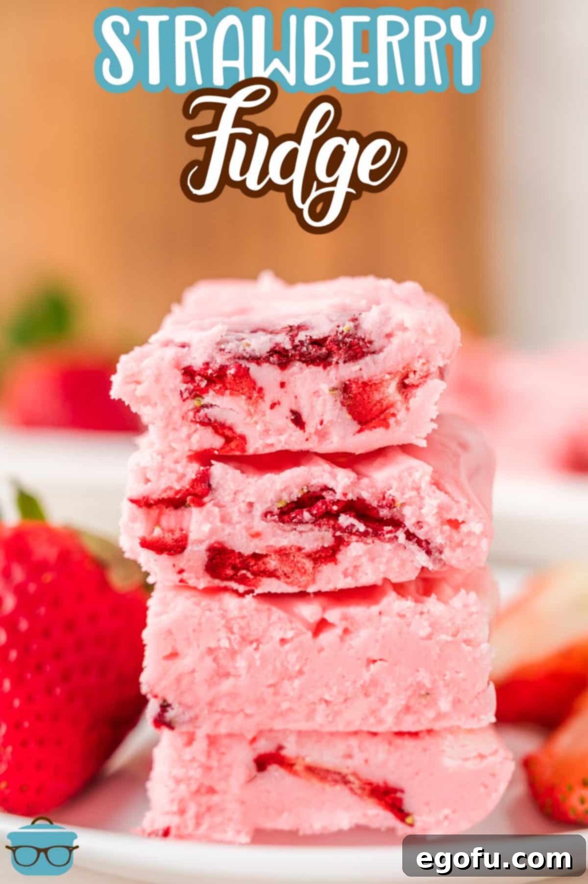 A small stack of a few pieces of Strawberry Fudge treat on a dessert plate, cut into perfect squares.