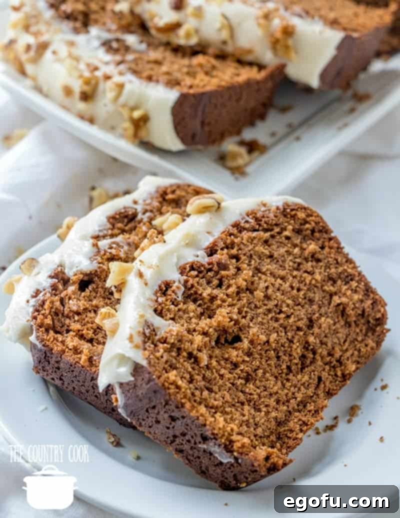 Homemade Starbuck's Gingerbread Loaf with Cream Cheese Frosting, sliced on a white tray.