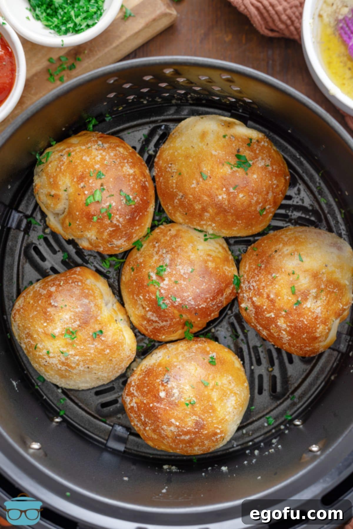 Looking down on an Air Fryer basket full of golden brown Air Fryer Pizza Bombs.
