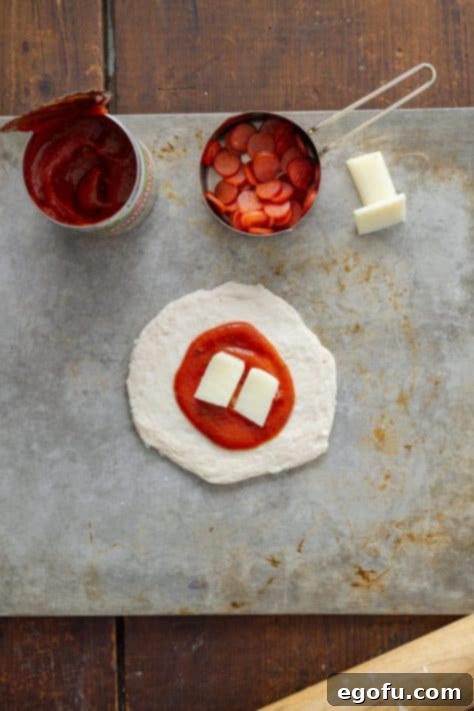 Biscuit dough, pizza sauce, and pieces of string cheese.