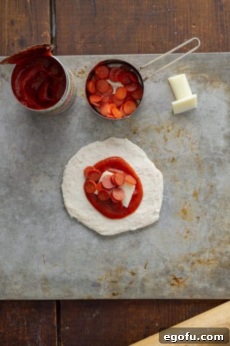 Biscuit dough, pizza sauce, string cheese, and pepperoni slices.