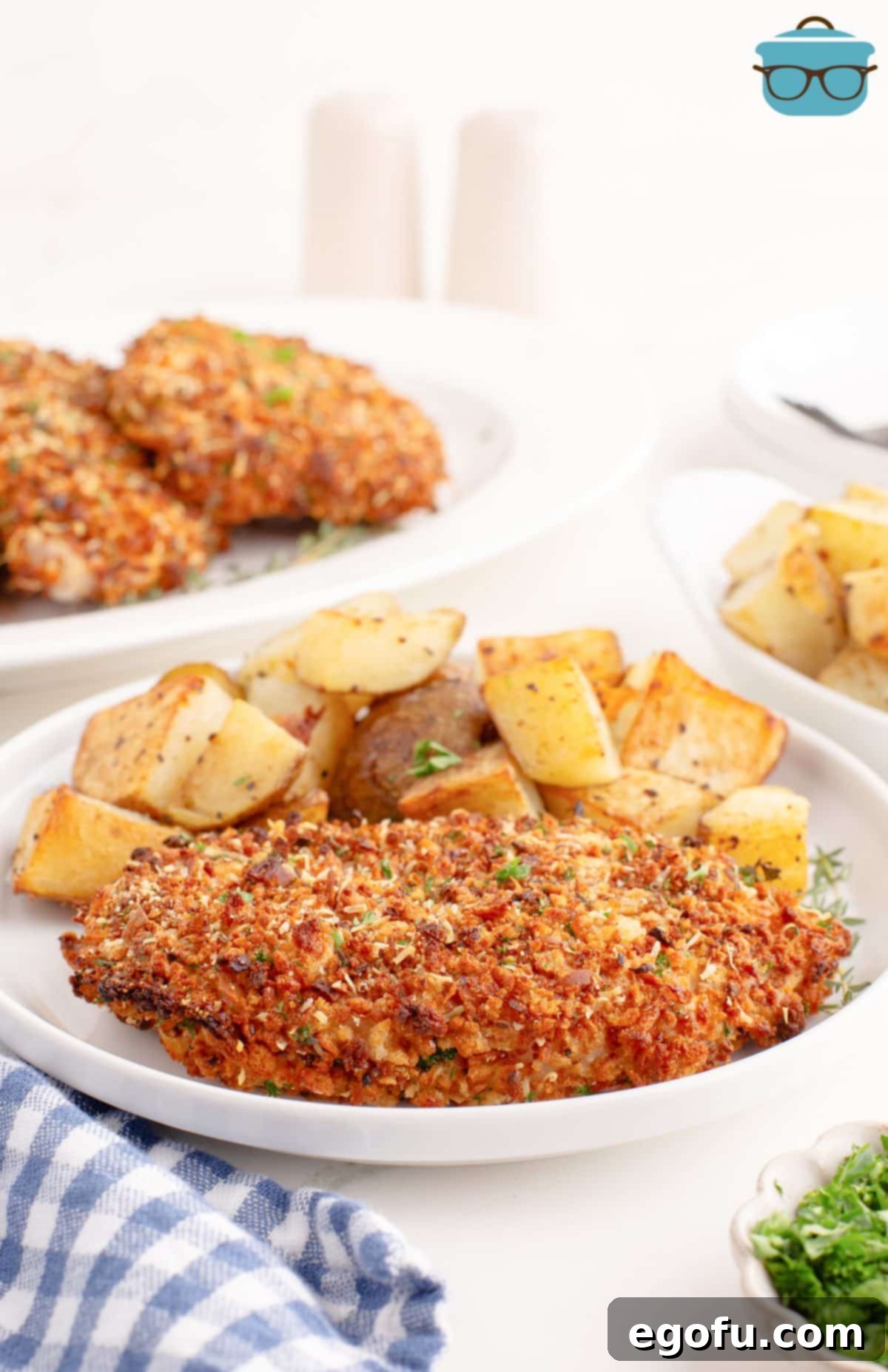 A dinner plate with potatoes and Crispy Baked Pork Chops.