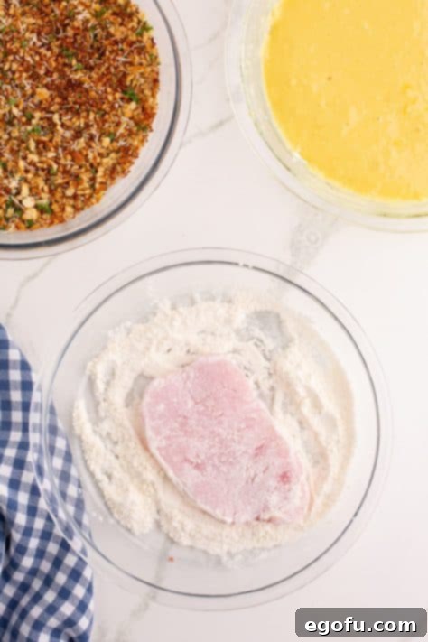 pork chop coated in flour mixture.