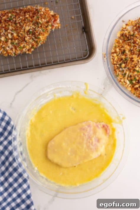 pork chop coated in egg mixture.