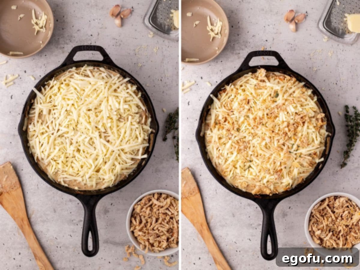 Shredded cheese and crispy fried onions added to a cast iron skillet mixture.