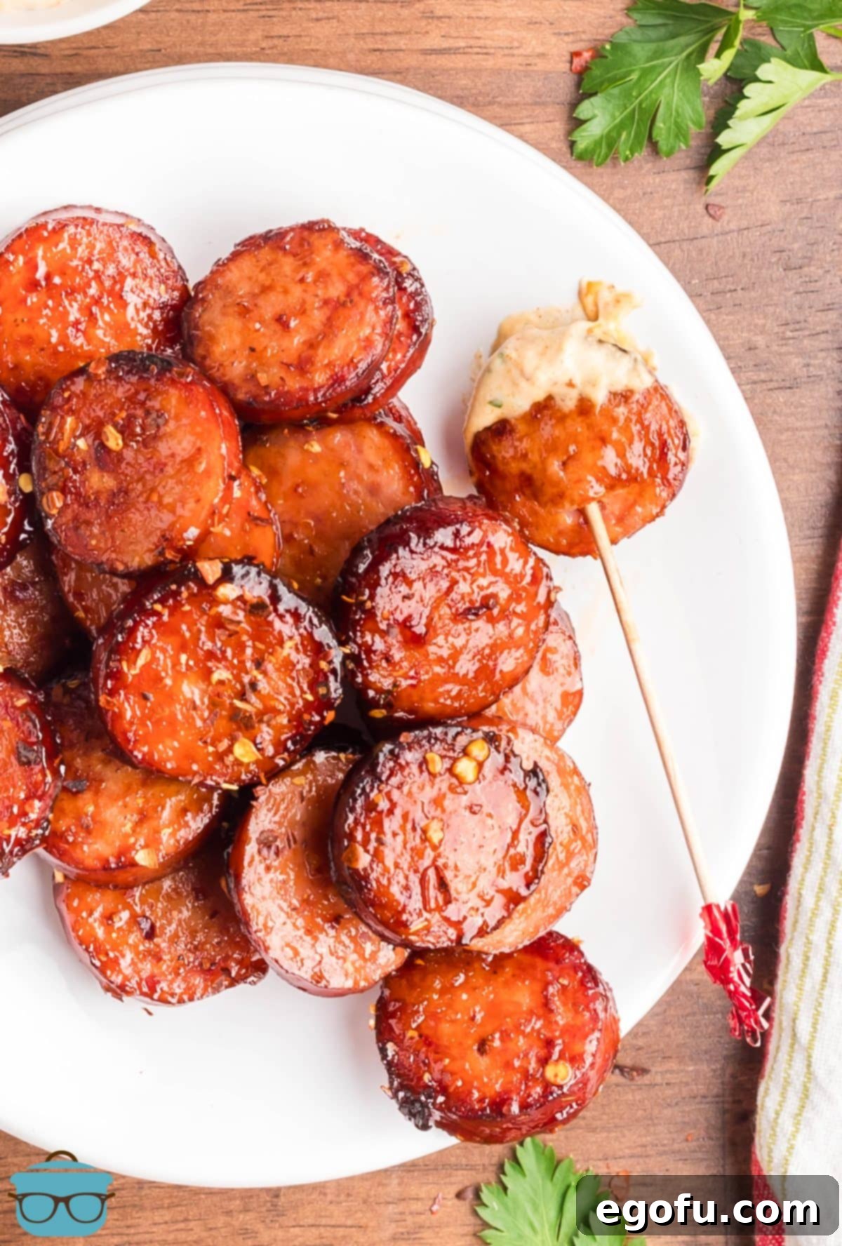 Sweet and Sticky Air Fryer Kielbasa 2 A plate of cut up Air Fryer Kielbasa pieces with sauce.