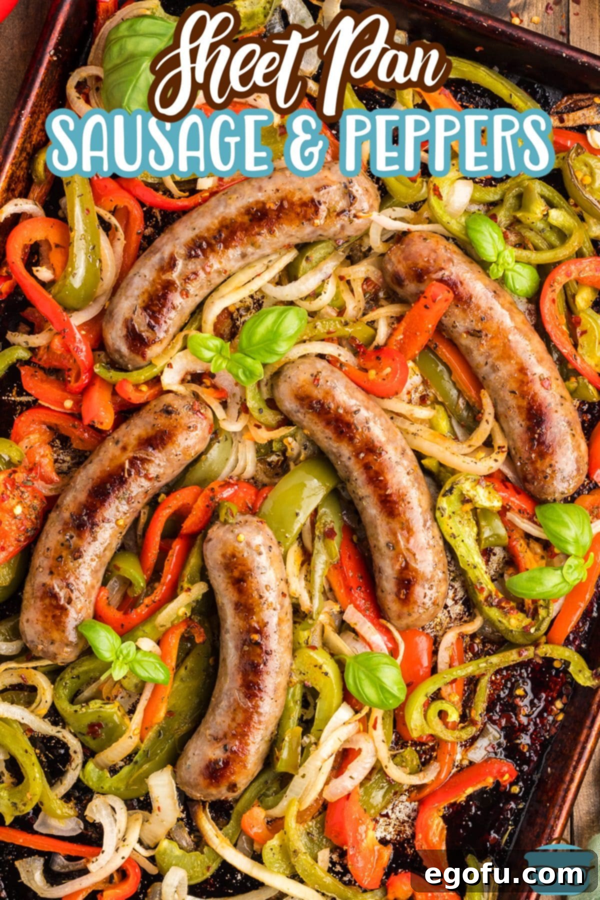 One Pan Sausage and Pepper Bake 3 A few pieces of sausage on top of sheet pan sliced bell peppers, illustrating the even roasting.