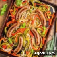 One Pan Sausage and Pepper Bake 7 Looking down on a sheet pan full of Sausage and Peppers.