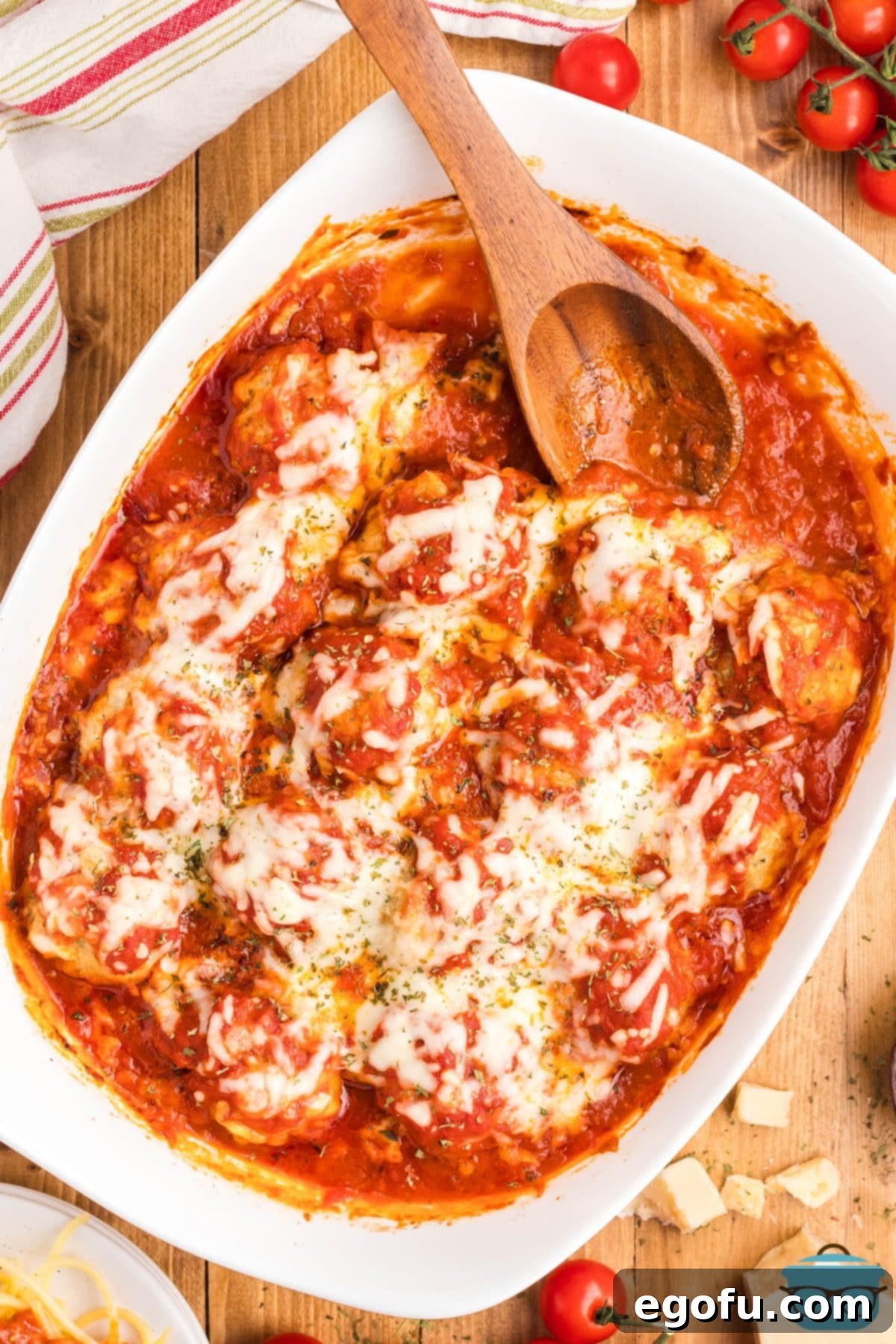 Chicken Parm Meatball Bake 2 Looking down on a large baking dish of Chicken Parmesan Meatballs, bubbling with marinara and melted cheese.
