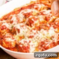 Chicken Parm Meatball Bake 11 A big serving bowl of Chicken Parmesan Meatballs, glistening with sauce and melted cheese.