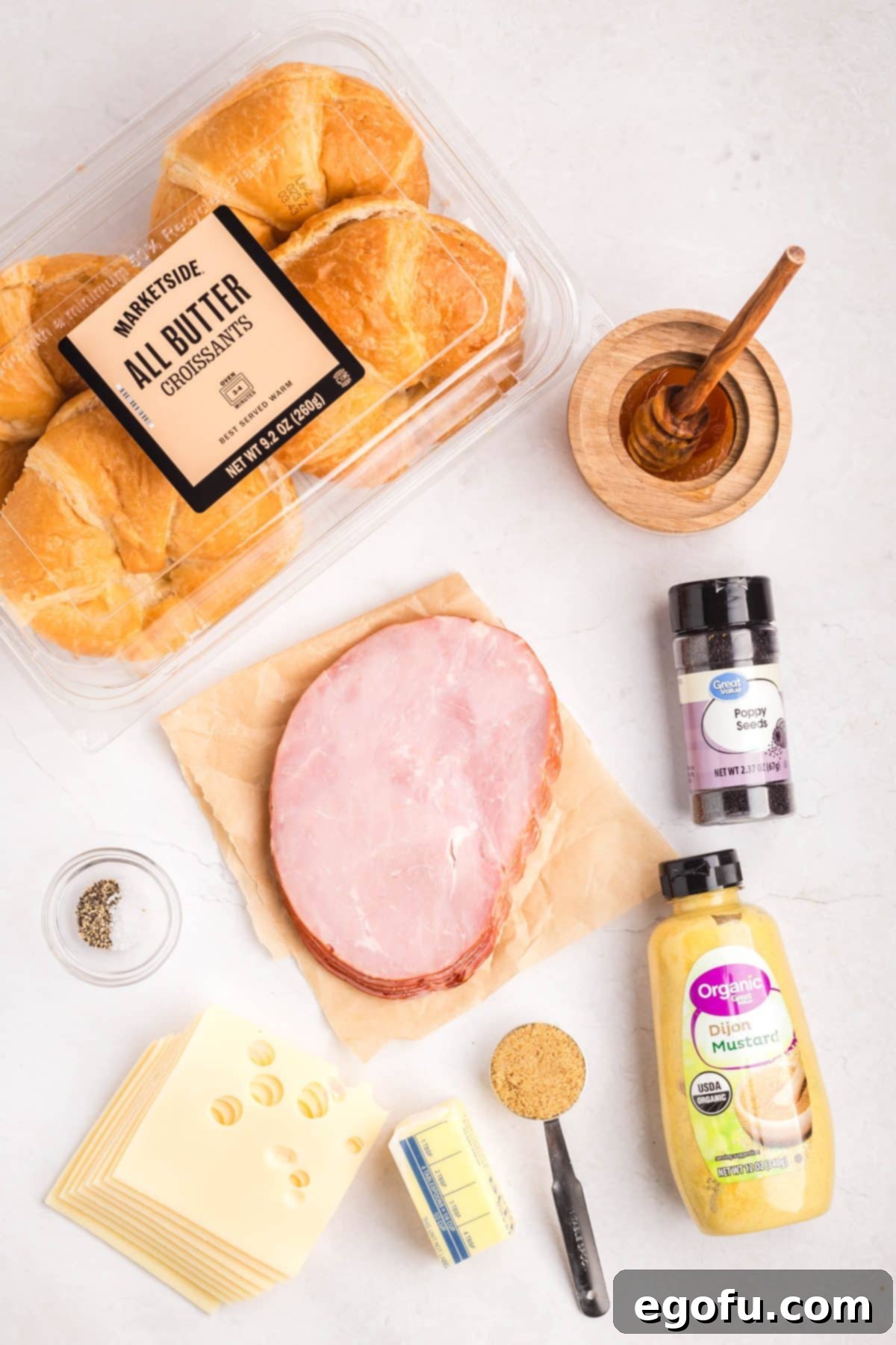 Butter, honey, brown sugar, Dijon mustard, salt, pepper, ham, croissants, Swiss cheese, and poppy seeds.