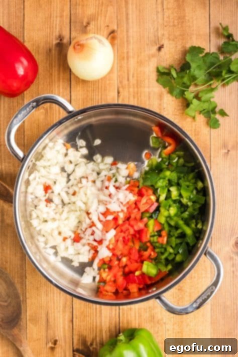 A pan with diced bell peppers and onions.
