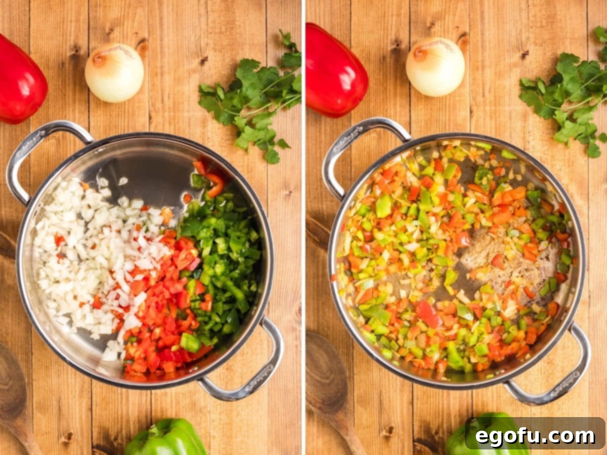 Diced peppers and onion in a sauté pan cooking.