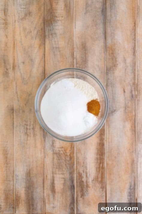 Starbucks Signature Cranberry Loaf 7 A bowl with flour, sugar, cinnamon, baking powder, and baking soda.