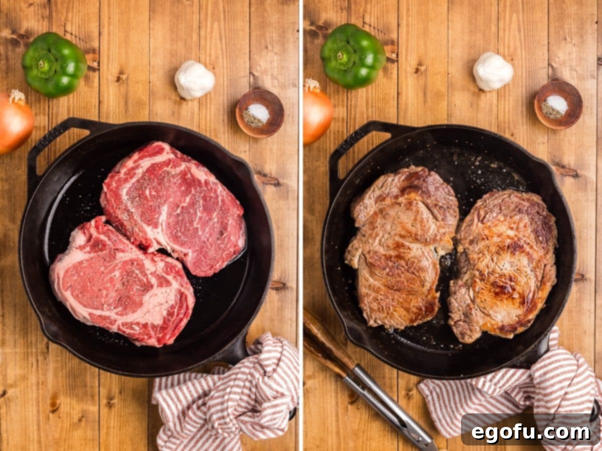 Seasoned steak in a skillet browning on both sides.