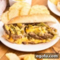 A plate with an open faced Philly Cheesesteak.