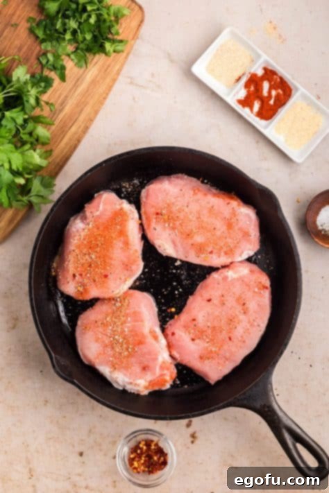Seasoned pork in a cast iron skillet.