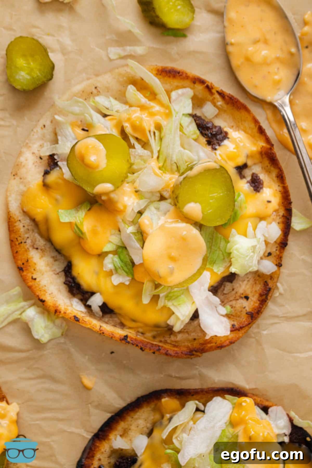 MacSmash Taco 2 Looking down on an open faced fresh made Big Mac Smashburger Taco, showcasing the crispy patty, melted cheese, fresh lettuce, and sauce drizzle.