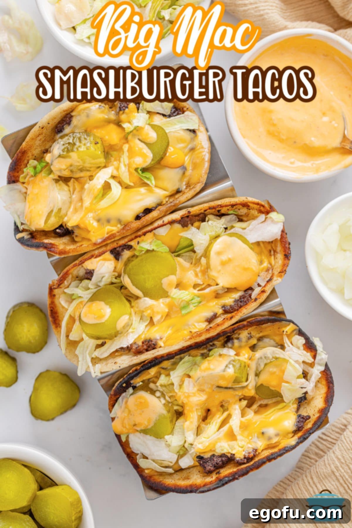 MacSmash Taco 9 Looking down on delicious Big Mac Smashburger Tacos, fully assembled with lettuce, pickles, onions, and sauce on a serving tray.