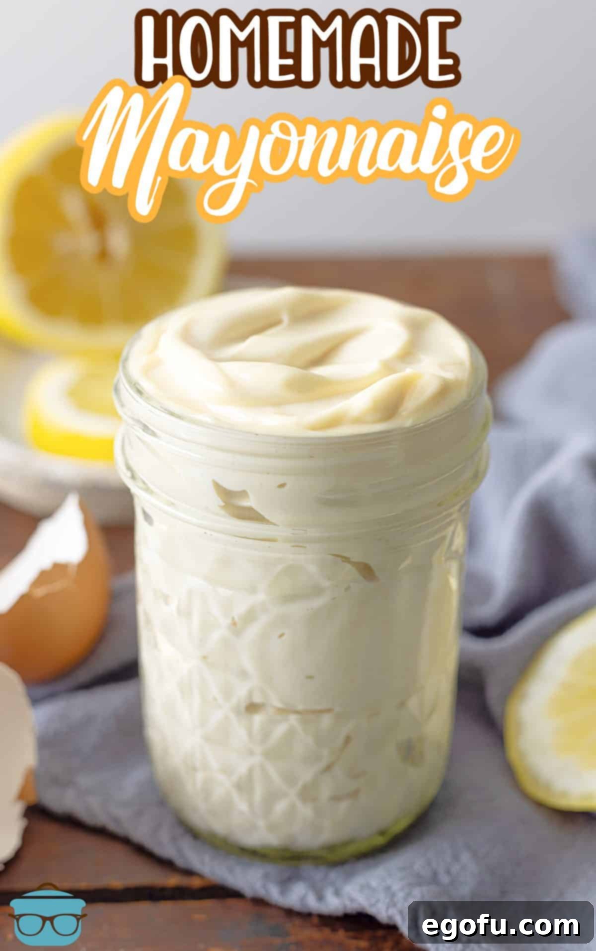 A beautifully presented, clear mason jar filled to the brim with glossy, white Homemade Mayonnaise, ready for use.