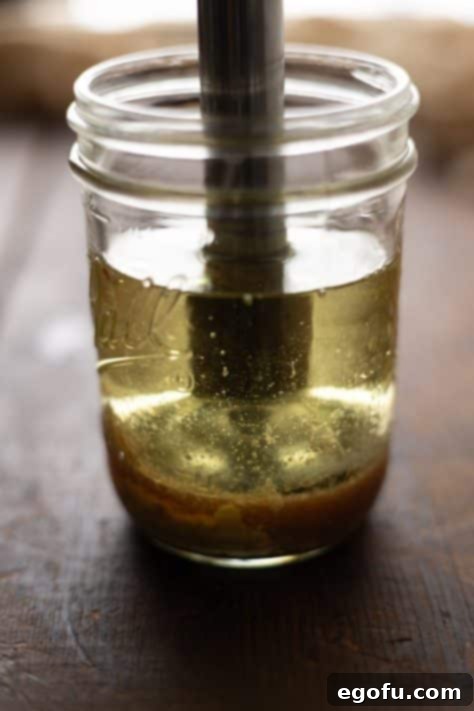 All the ingredients are carefully layered into a mason jar, ready for blending to create delicious homemade mayonnaise.