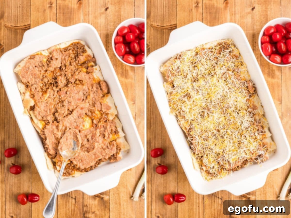 Refried beans and shredded cheese added over the meat and tortilla layers in the casserole dish.