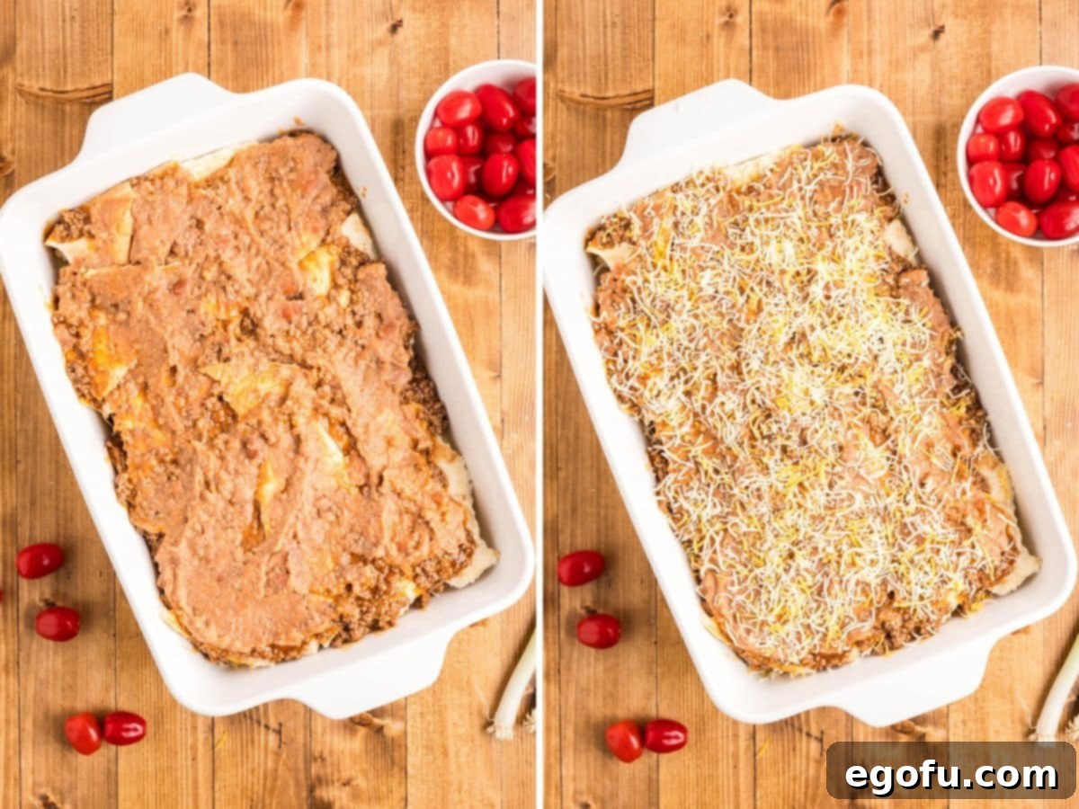 The final layers of refried beans and cheese being added to the top of the Mexican pizza casserole.