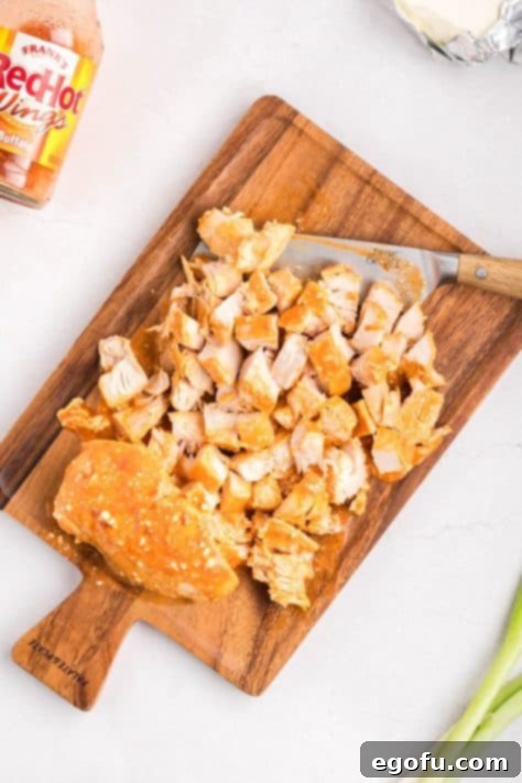 Chicken chopped on a cutting board.