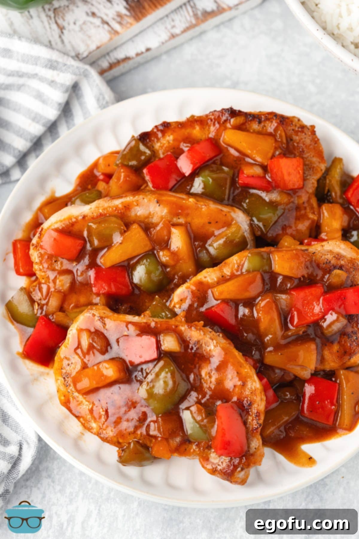 Looking down on a plate of rice and tons of sauce with the Sweet and Sour Pork Chops.