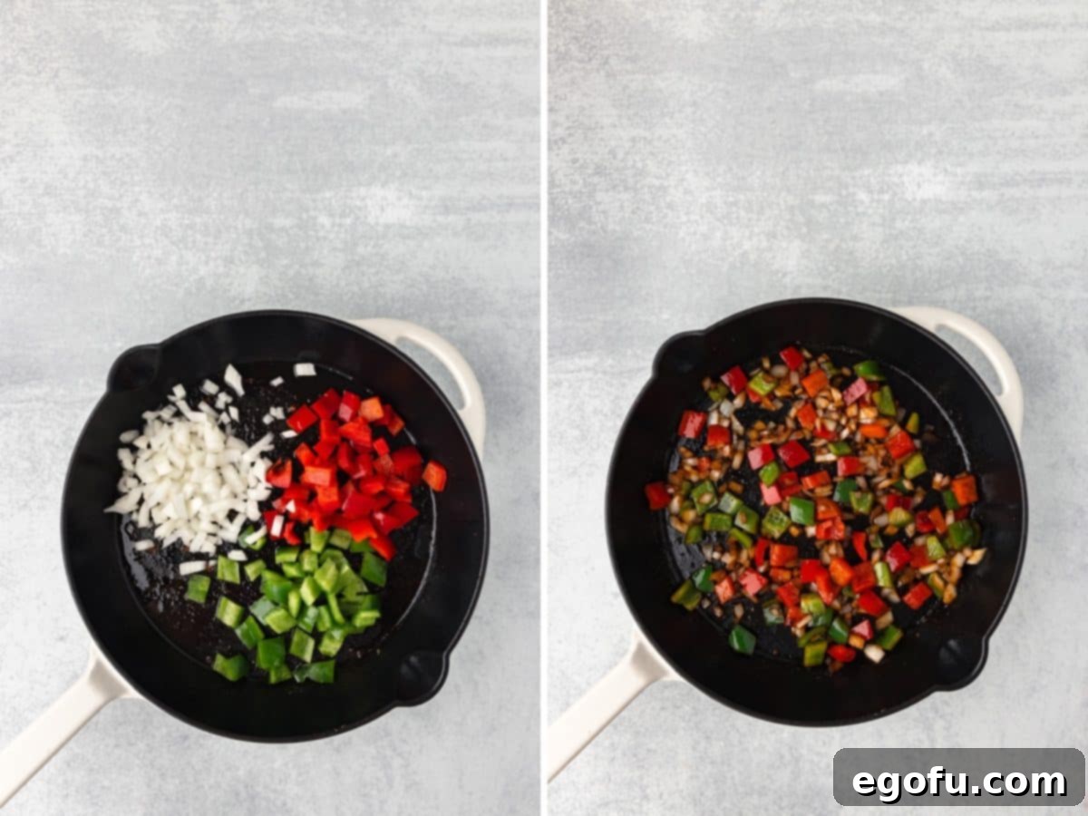 Onions and bell peppers cooking in oil in a skillet.