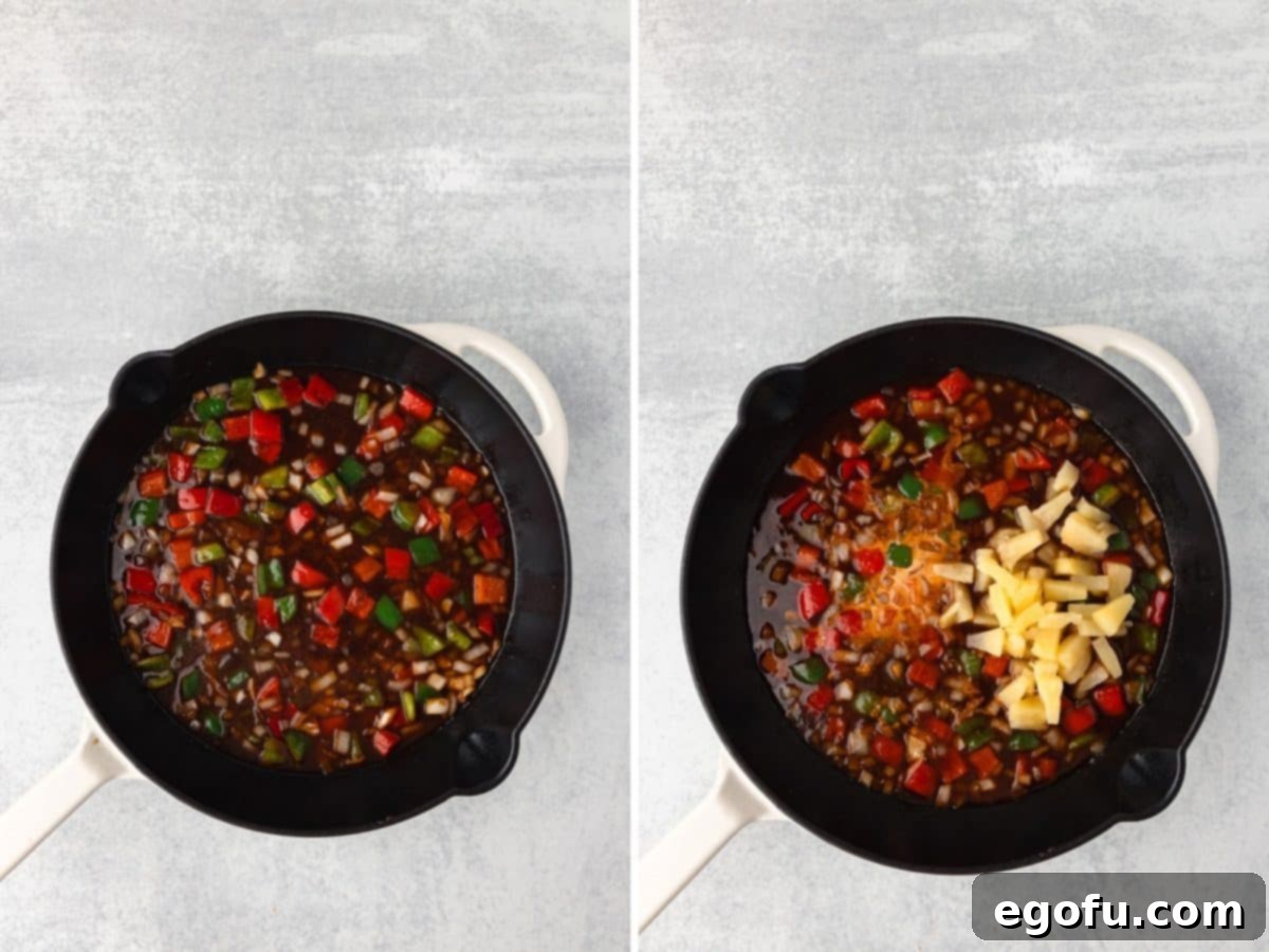 Veggies cooking in a sauce in a skillet.