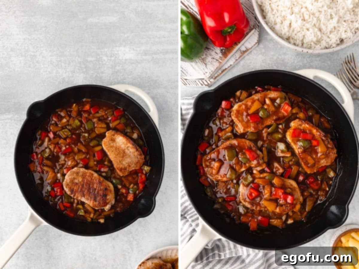 Pork chops in a sauce in a skillet.
