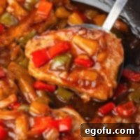 A serving utensil holding a scoop of Sweet and Sour Pork Chops, thumbnail size.