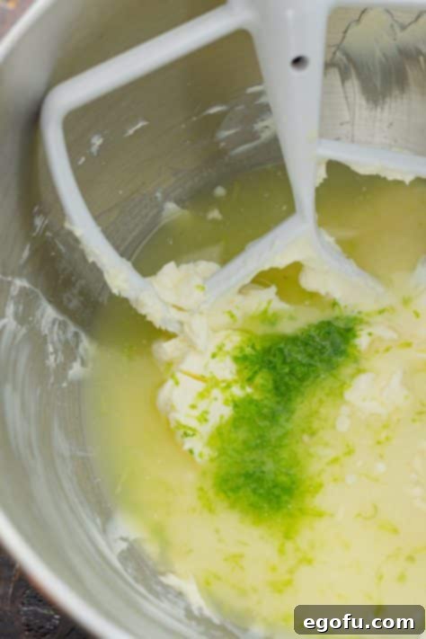 Lime zest, lime juice, and cream cheese being whipped together to form the Key lime filling.