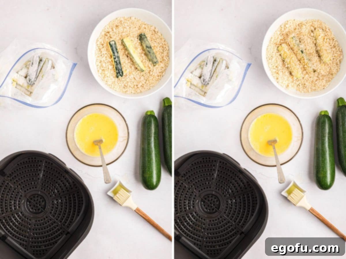 Egg coated zucchini sticks being coated with breadcrumb mixutre.
