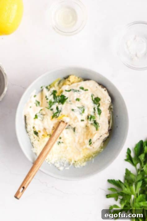 A Lemon Garlic Aioli dip being mixed together in a bowl.