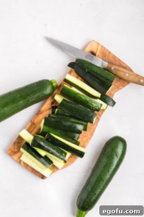 Zucchini being cut into sticks.
