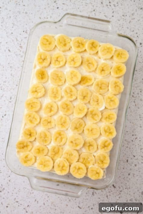 Sliced bananas over a cream cheese layer.