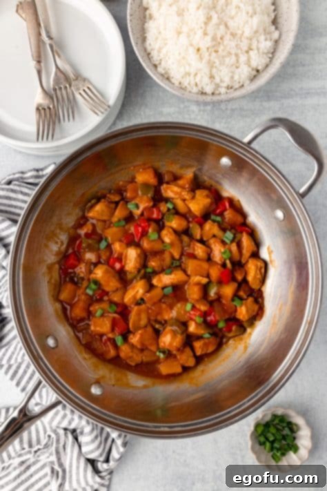 Thickened and glossy Hawaiian Chicken stir fry sauce coating all ingredients in the pan.