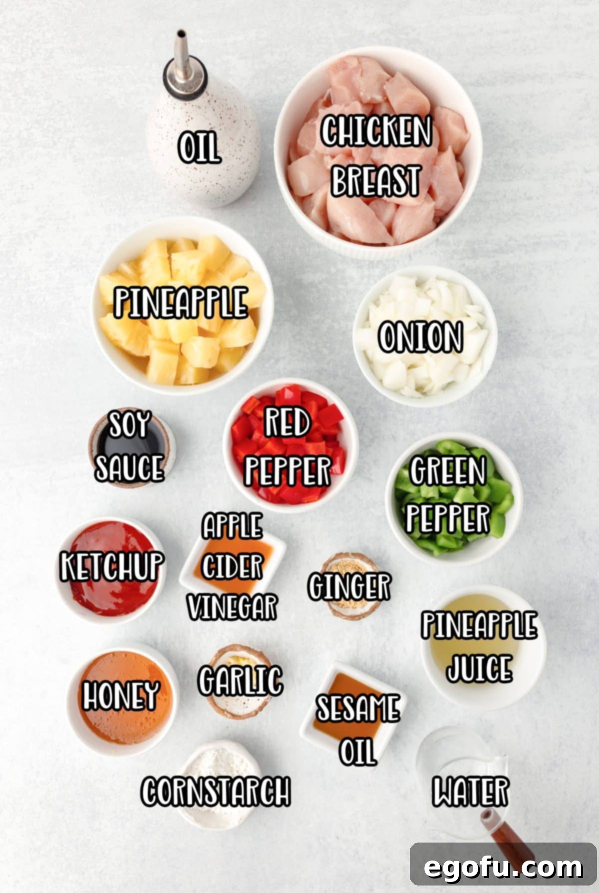 A vibrant display of all the ingredients needed for Hawaiian Chicken: diced chicken breast, various oils, red pepper, green pepper, onion, pineapple chunks with juice, ketchup, honey, soy sauce, apple cider vinegar, sesame oil, minced garlic, ginger powder, cornstarch, water, and sliced green onions.