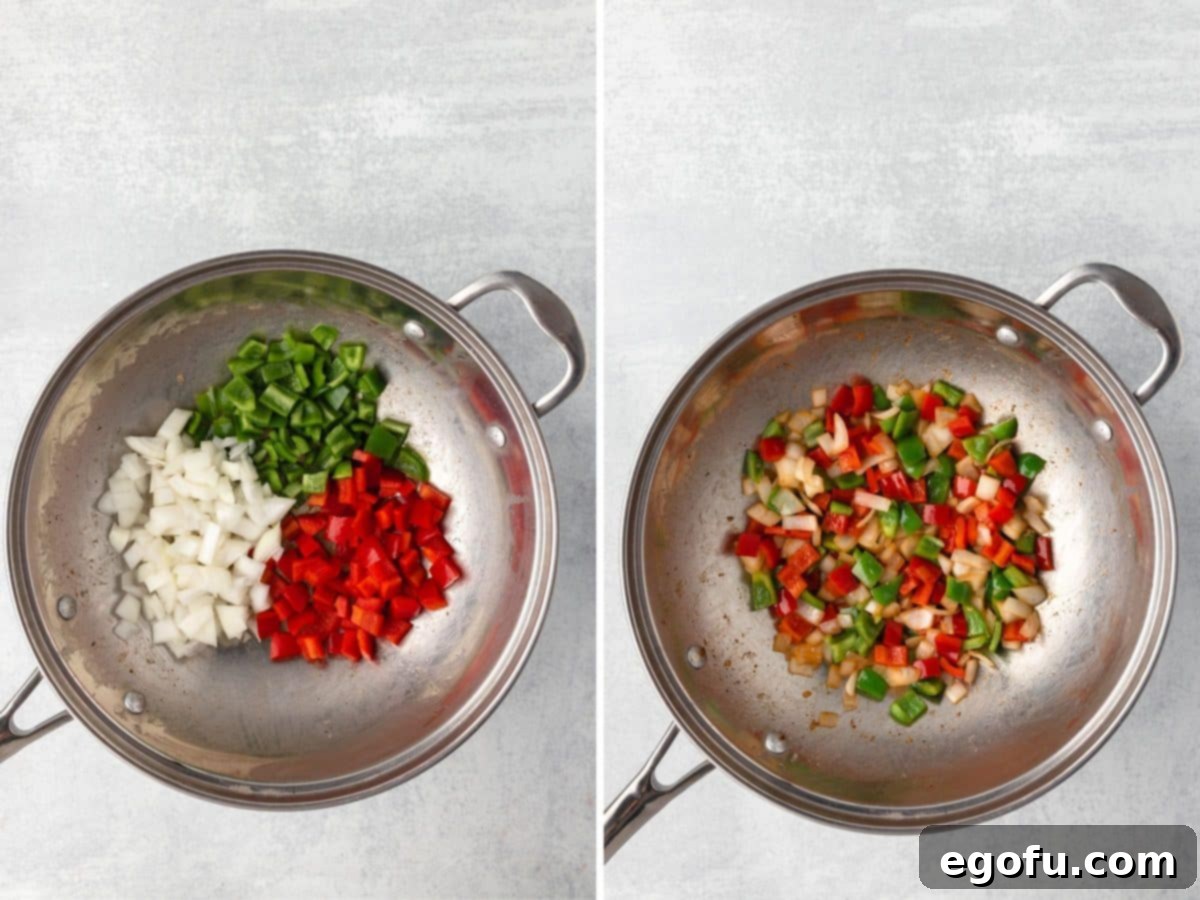 A pan with onions, red pepper, and green peppers being stir-fried until they begin to soften.