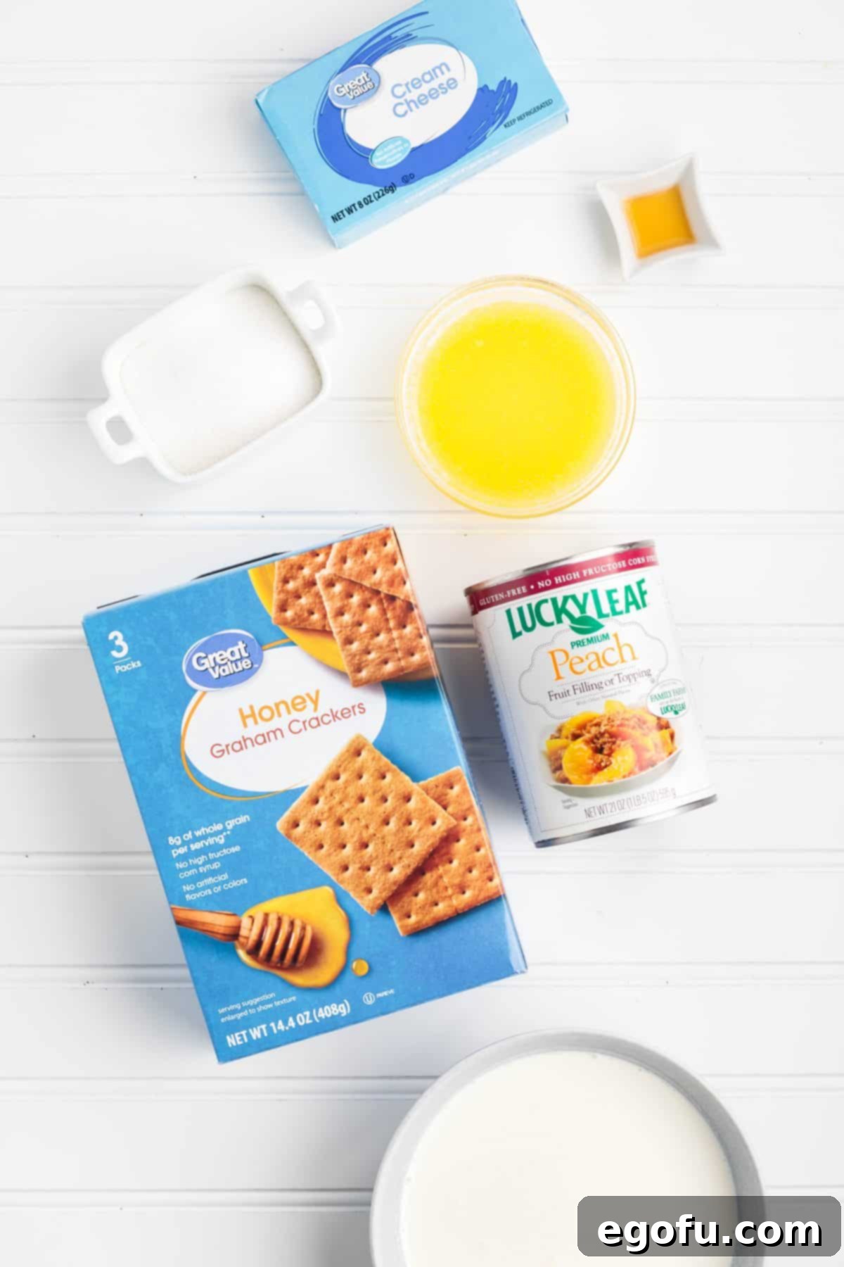 Graham crackers, melted butter, peach pie filling, sugar, cream cheese, heavy whipping cream, and vanilla extract.