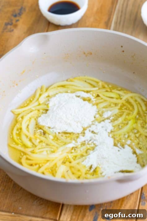 Tender Pork Bites in Rich Gravy 13 Flour added to the onion and butter mixture in the skillet, being whisked to form a roux.