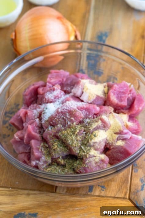 Tender Pork Bites in Rich Gravy 10 Herbs coating raw pork bites, ready for searing.